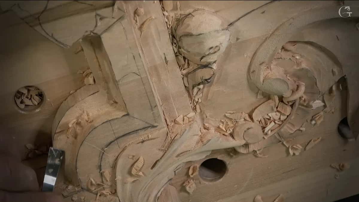 Steel edge resting on the carved curve, lower left
