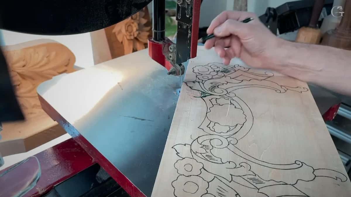 A pen tip points along the inked line near the blade, the board flat on the steel