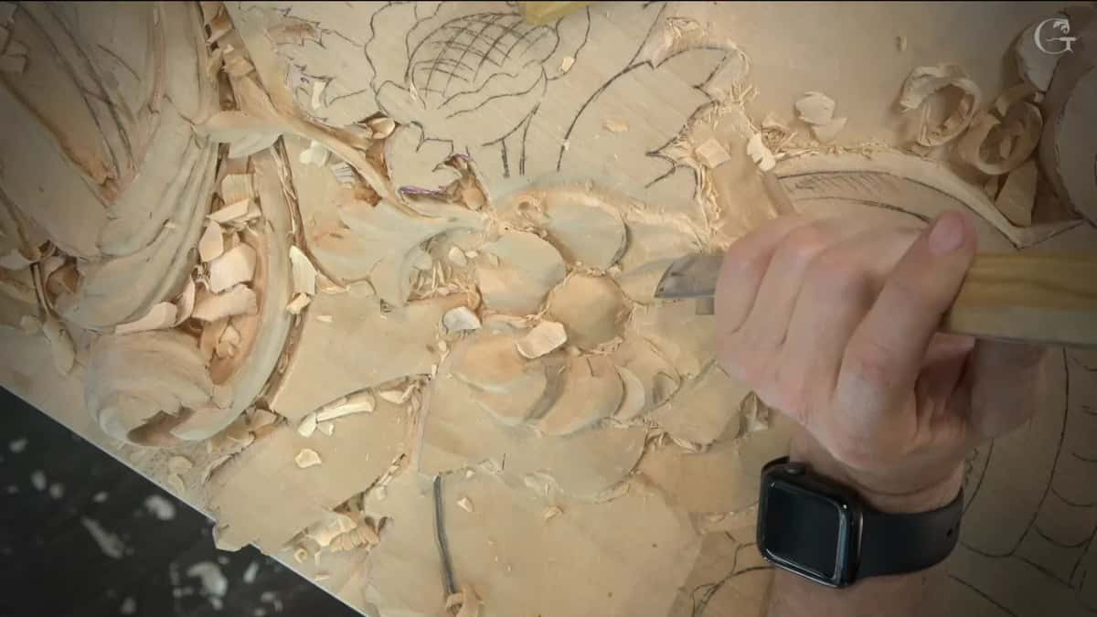 Gouge in hand, digging a hollow into one petal