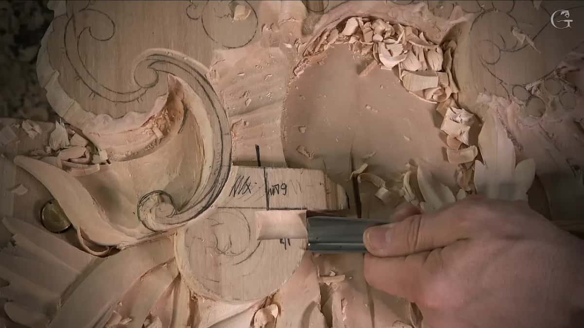 One hand drives a flat blade along the top of the block