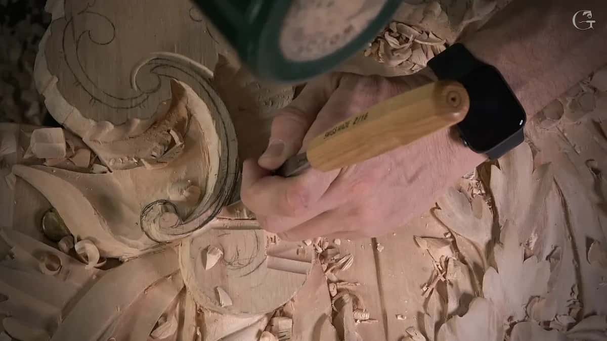 Mallet raised over a gouge on the line