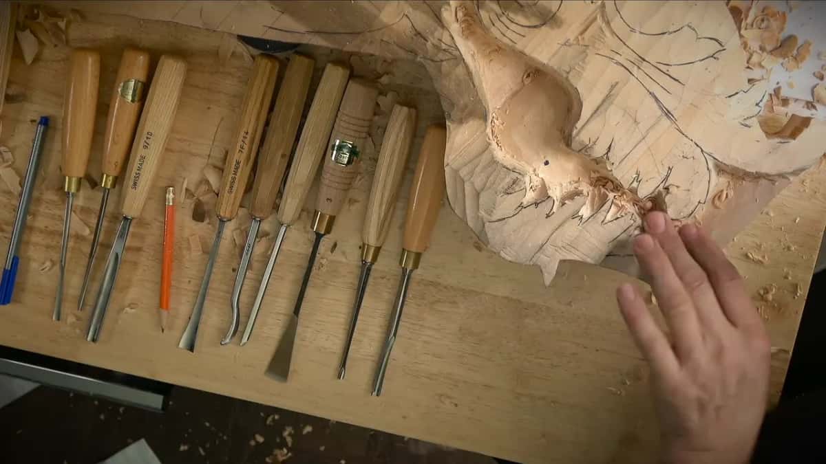 A row of gouges on the bench beside the drop, a small hole showing in the hollow