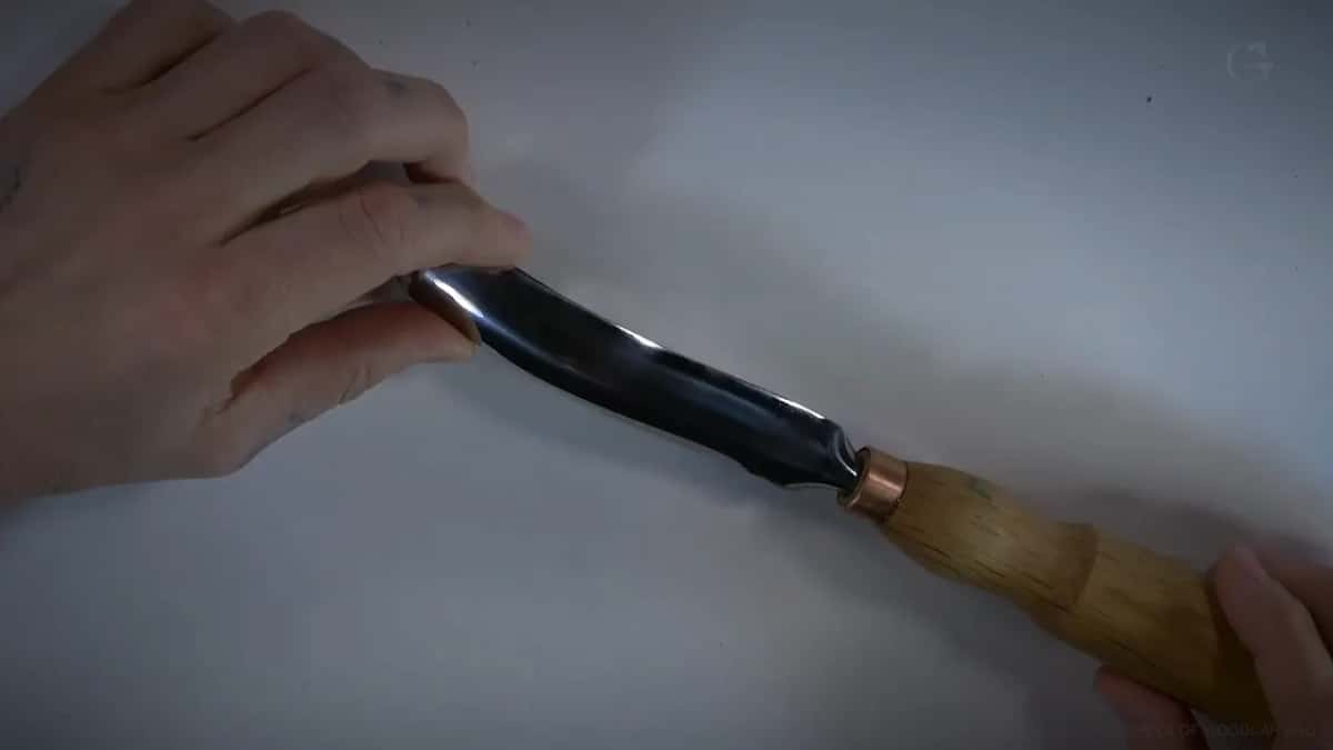 Curved sweep of the big bent tool, seen in the hand.
