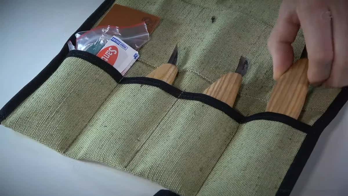 Canvas roll open, knives in their pockets, a packet of Band-Aids tucked at the left.