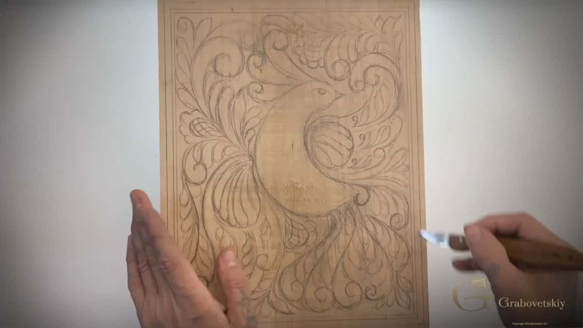 The whole pencil drawing seen from above, one hand flat on the left and the knife held off to the right