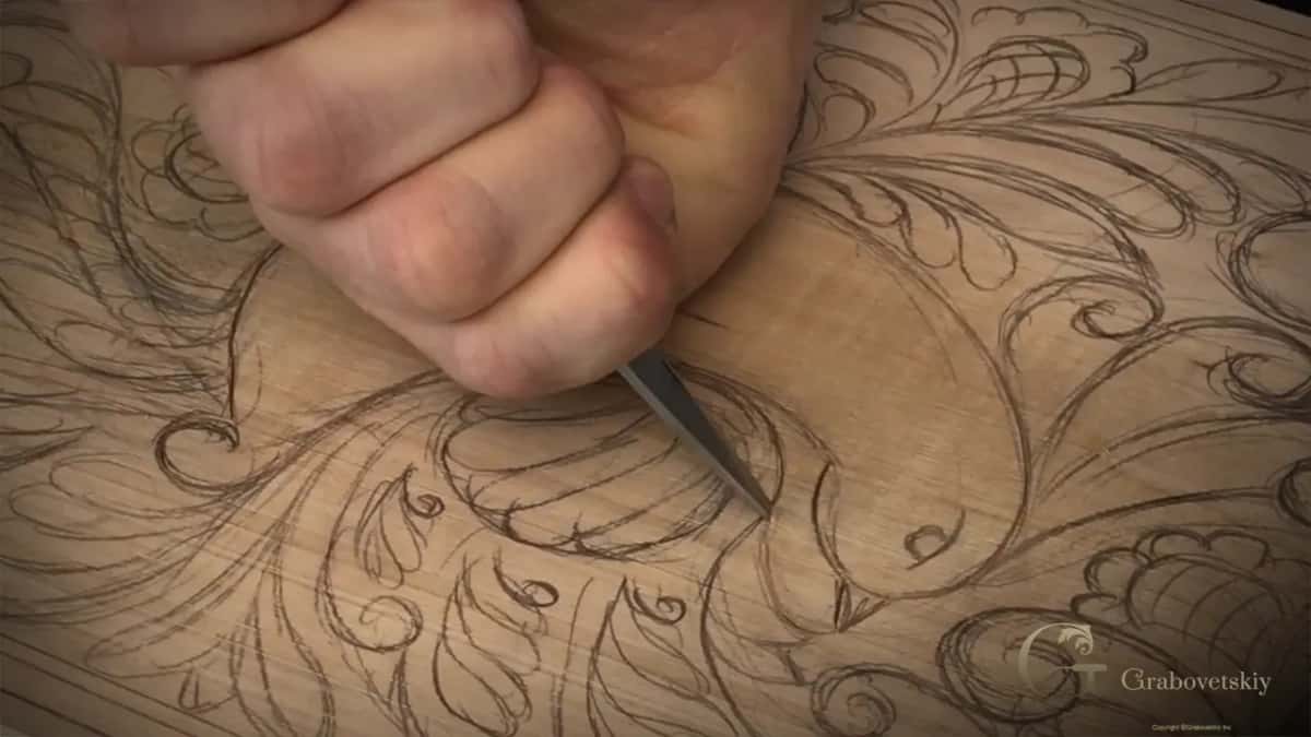 Fist round the handle, blade leaning in at the head
