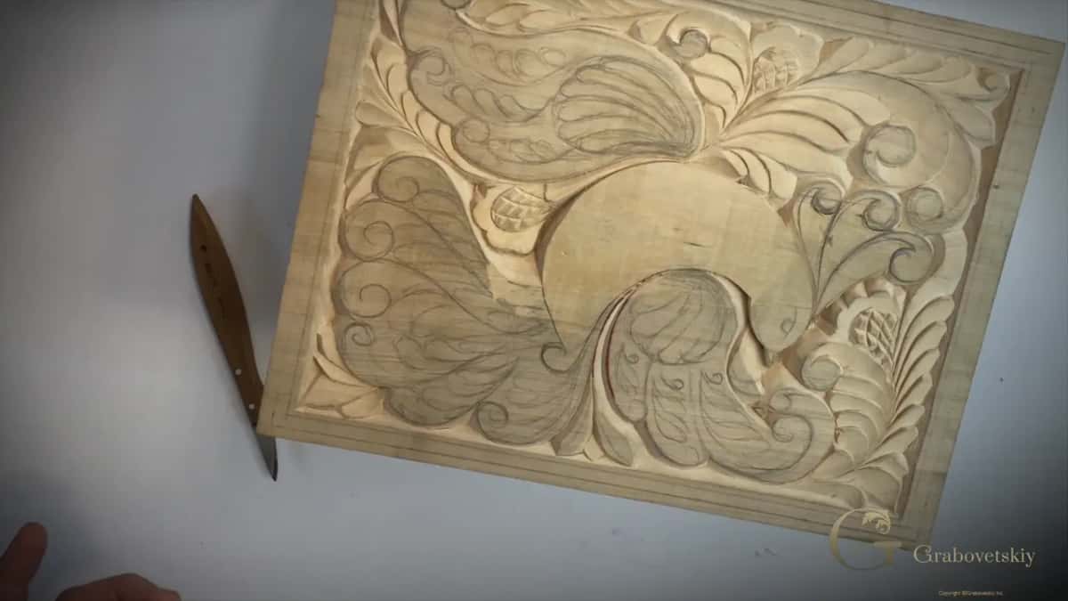 Whole board on a white bench, the knife lying beside it