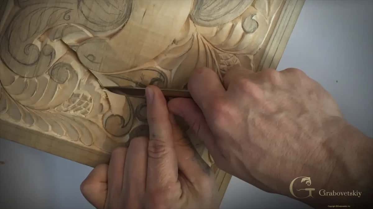 Knife held low along a curl, a second hand under it