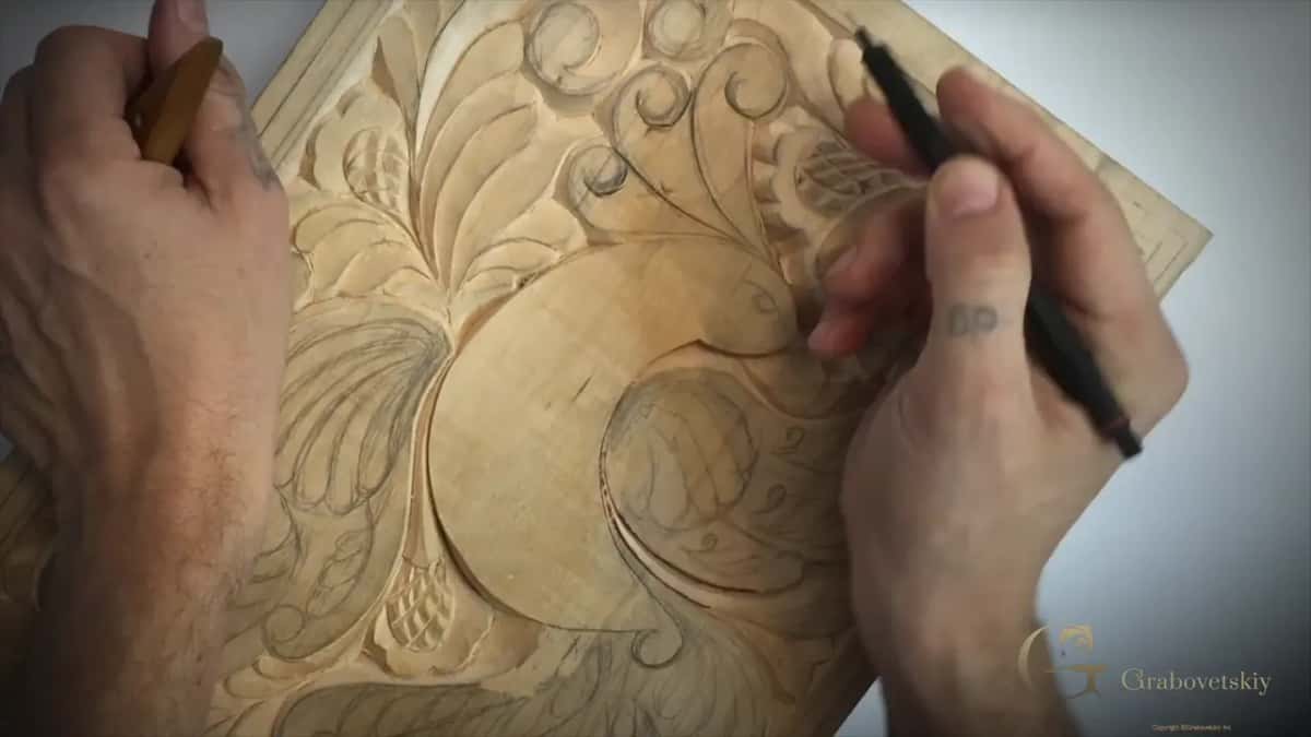 Knife in one hand while the other draws a curl with a black pen