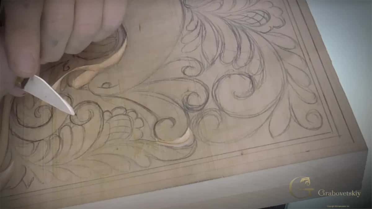 A curved groove opens beside the blade in the top left corner of the panel.
