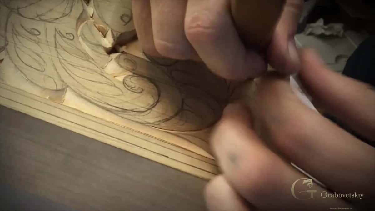 Low and close, fingertips at a curl above the border