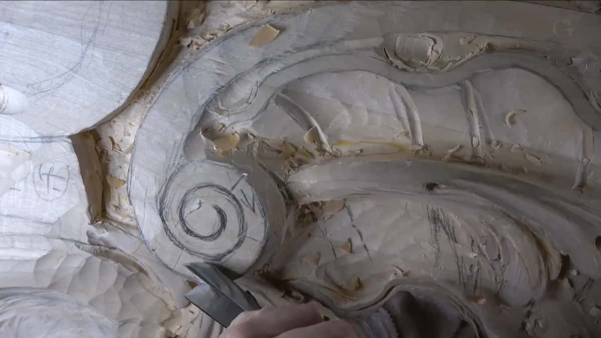 Drawn spiral on the volute, a gouge below.