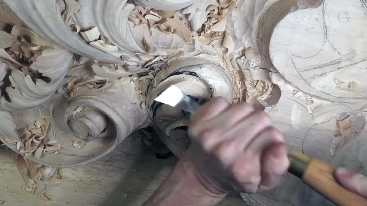 The blade slips in under a round rim, shavings everywhere.