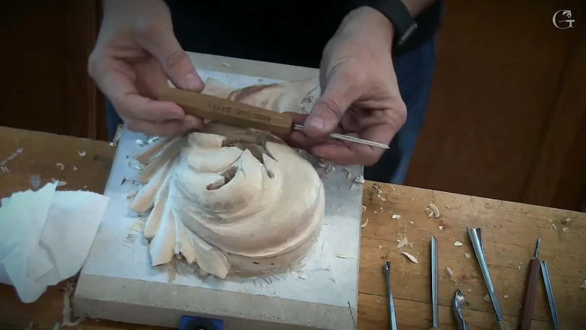 Pale handle, thin blade, both hands over the curl