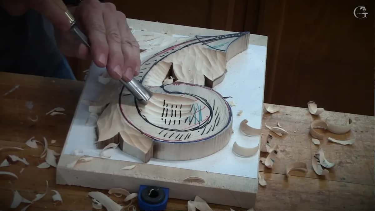 Into the scroll hollow from the left, shavings piled up on the bench all around