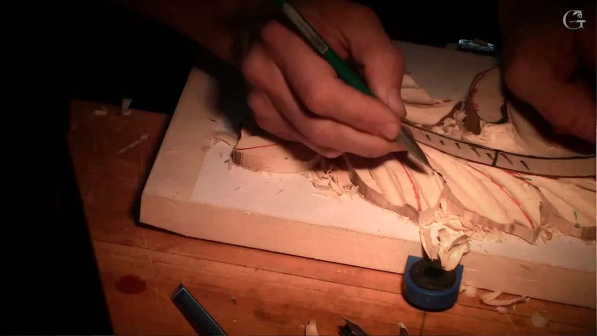 A green-handled tool works a leaf right beside the black band with its tick marks