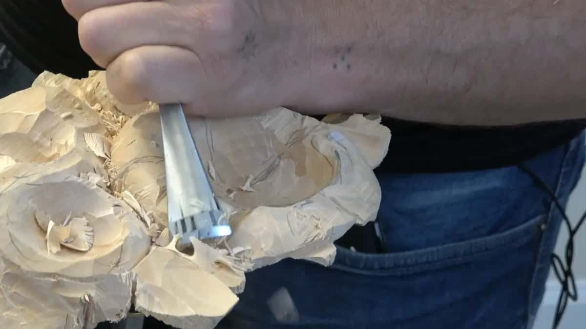 V tool in a fist, its deep V profile showing