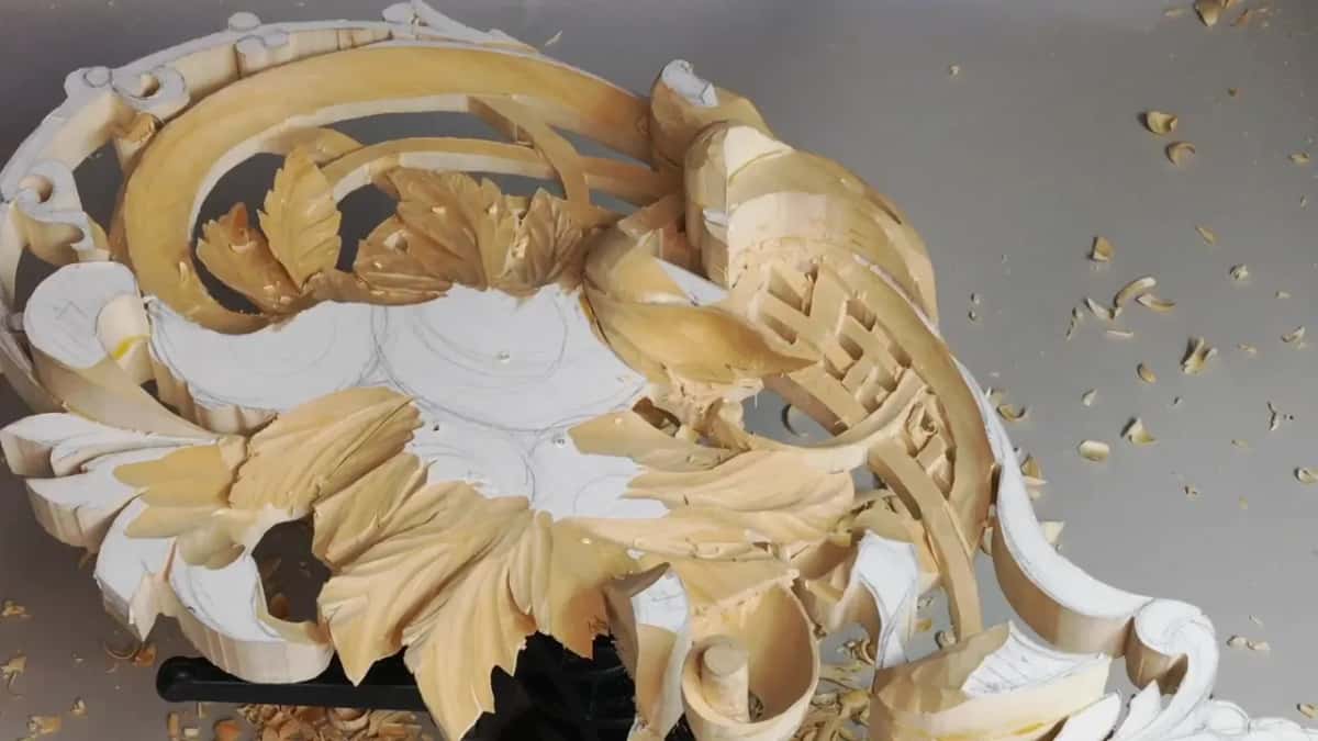 Leaves and scrolls seen low and sideways, with no hands in the frame and chips below