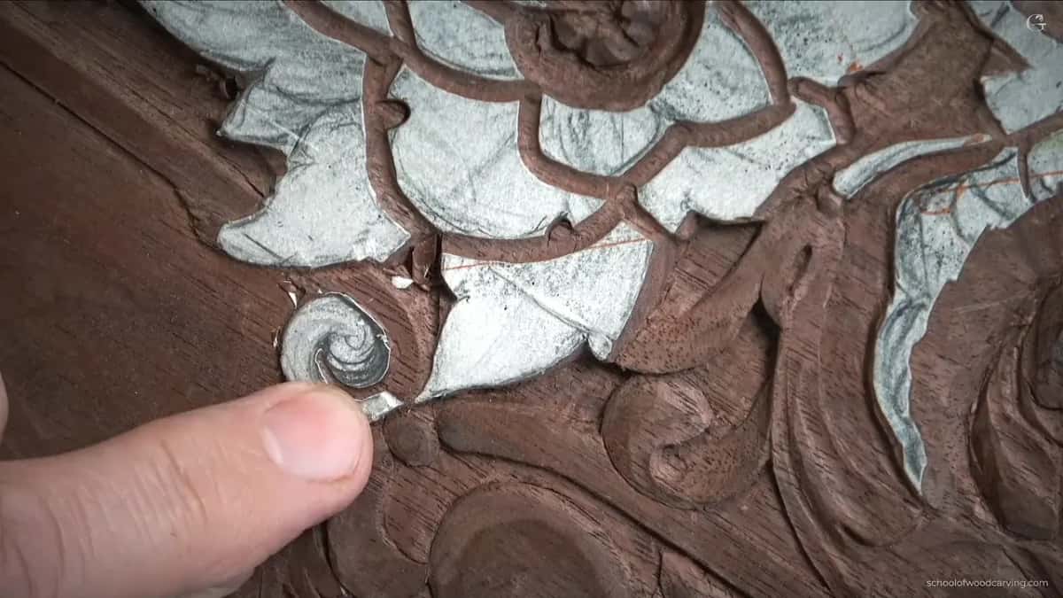 Thumb at the small volute, still covered by its paper pattern