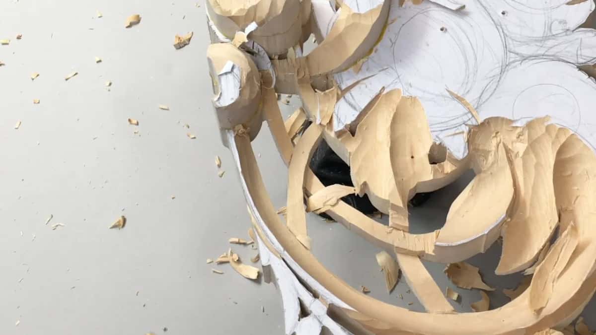 Leaves roughed in, crowding the curved straps, no tool in the frame