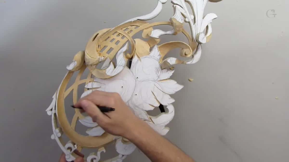 Pencil in hand over the paper pattern of the flowers, the panel seen from above