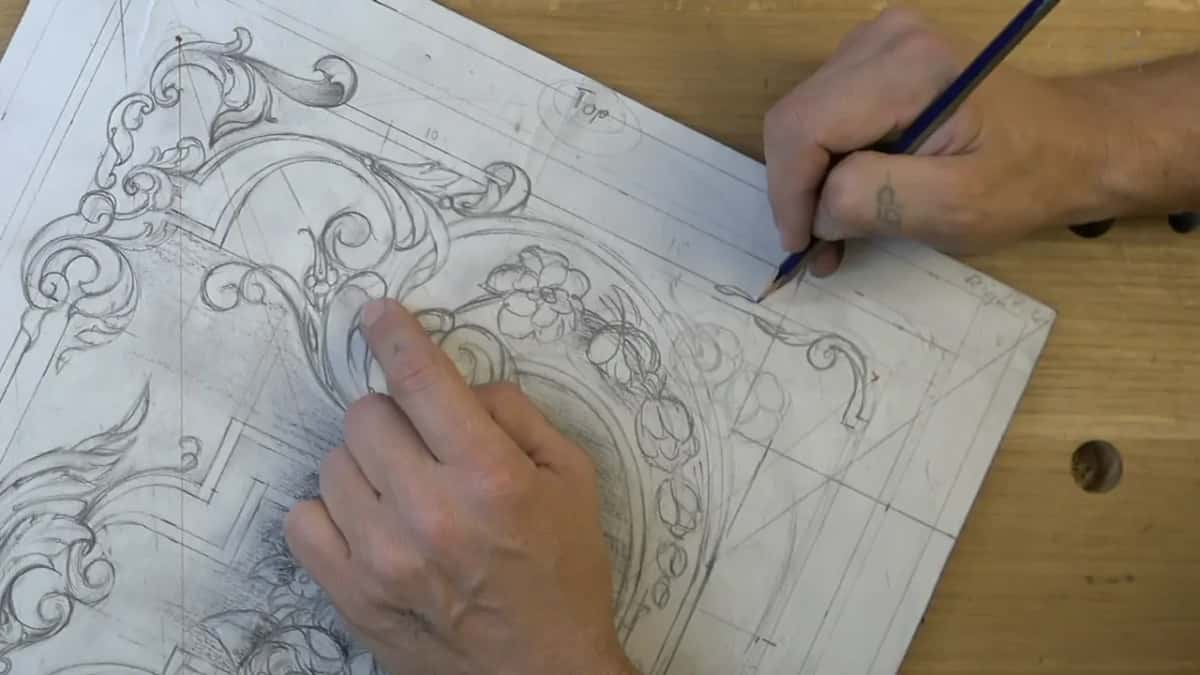 One finger rests on the arch while a blue pencil adds a small curl near the right border