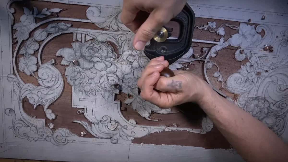 Router plane held over the center of the board with shavings scattered around it