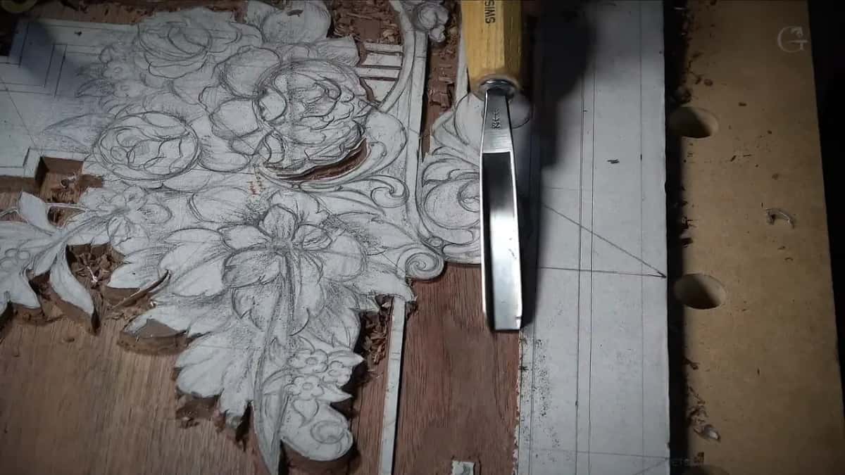 Upright gouge on the line at the right, its handle stamped SWISS, beside paper-covered flowers