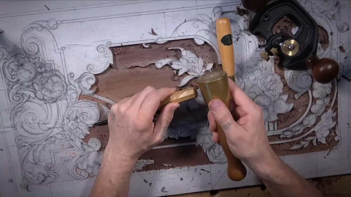 Mallet raised over a gouge