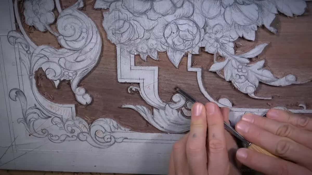 Gouge held in two hands at the scroll