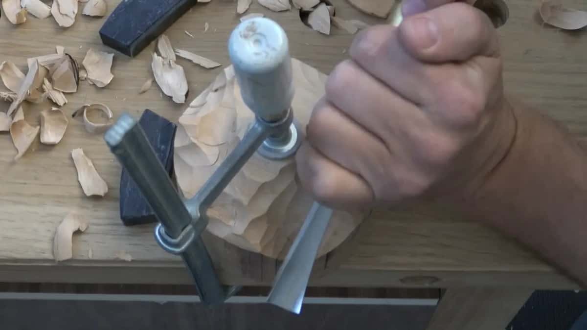 Knuckles over a gouge beside the clamp handle