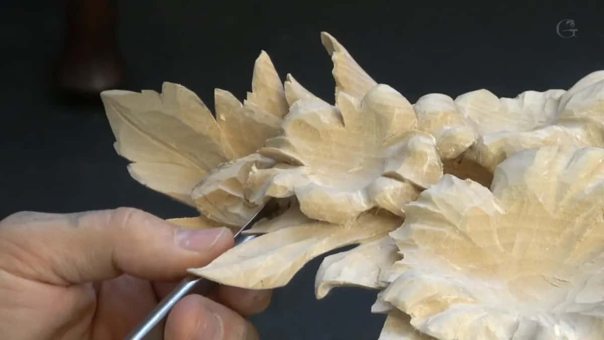 A slim tool under the lowest leaves