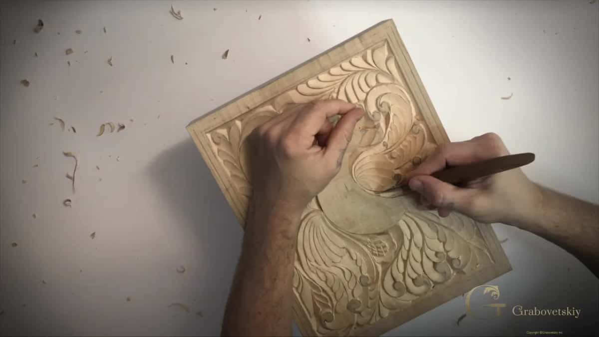 Seen from above, my left hand rests at the top while a dark knife works near the bird's head