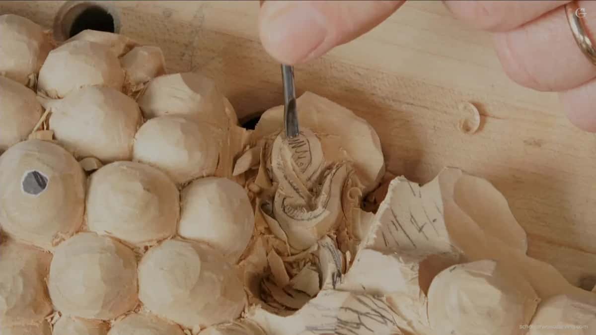 Tiny gouge working down into the carved strand