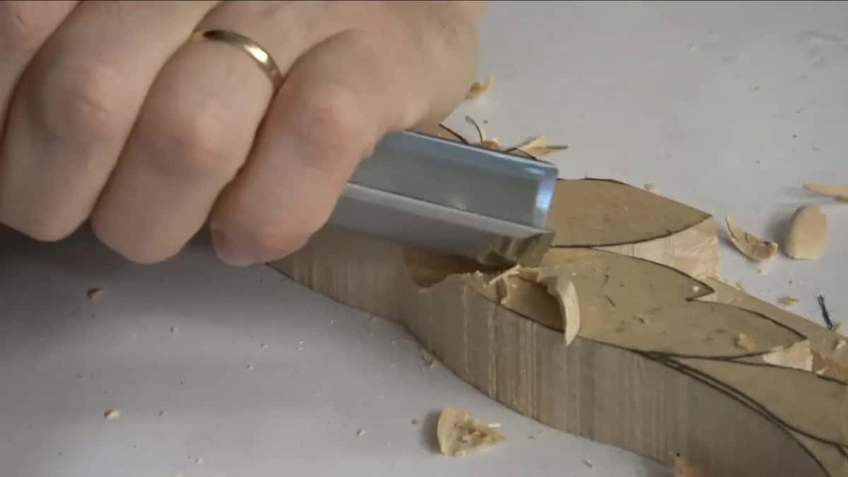 A fist around a wide gouge.