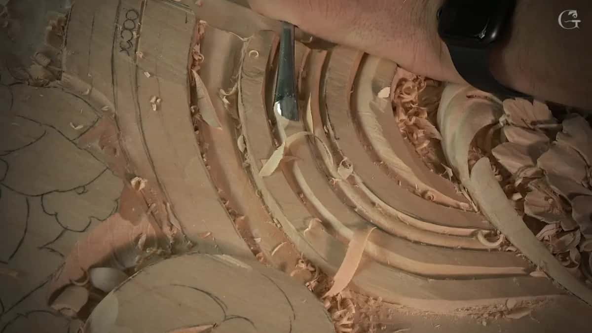 Long pale shaving coming off the top of a band