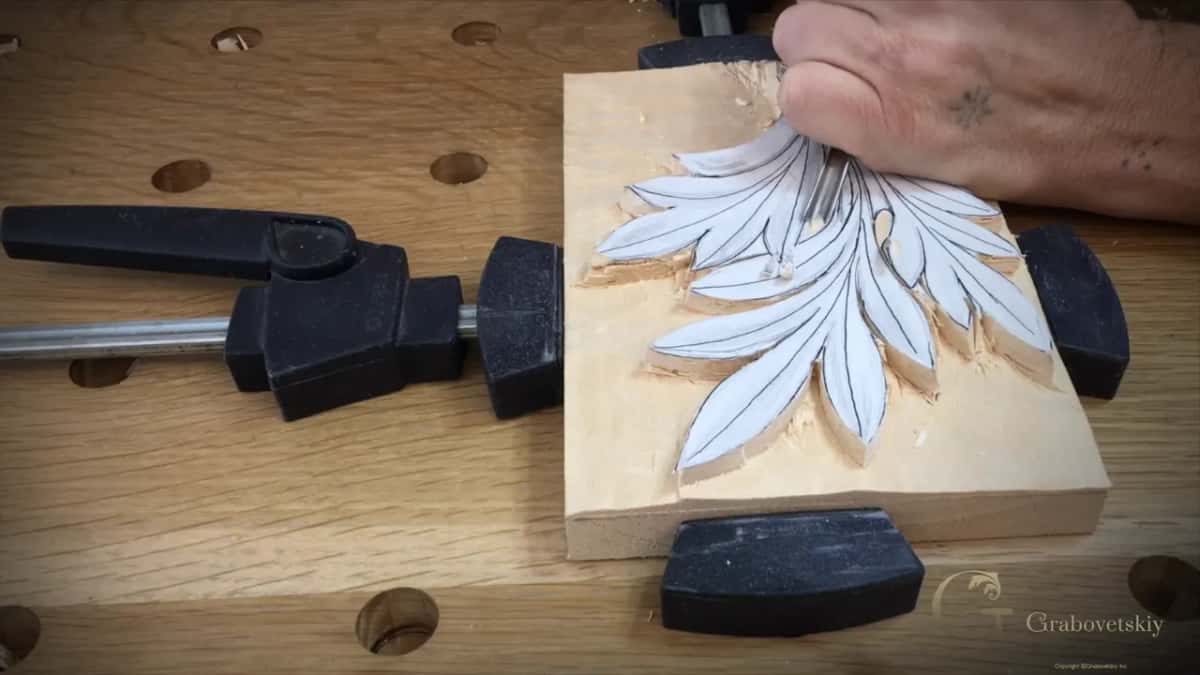 A hand at the top of the paper leaf, chips along its edge