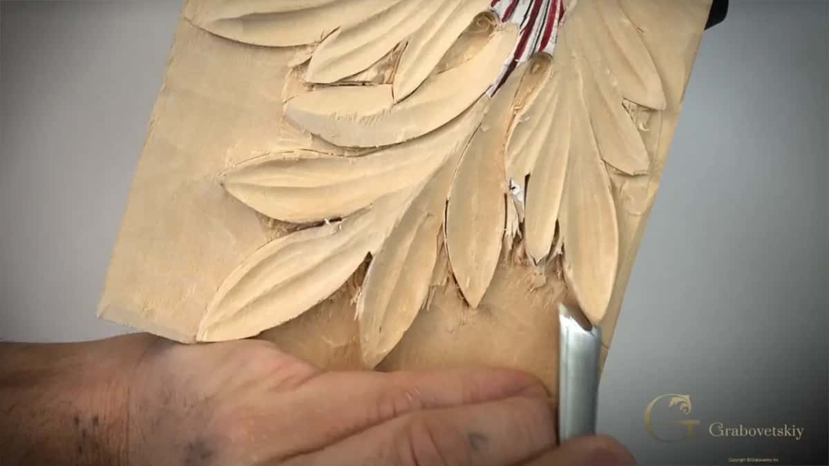 Gouge laid low at the lower edge, palm flat on the wood