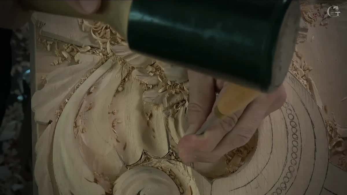 Dark mallet over a hand