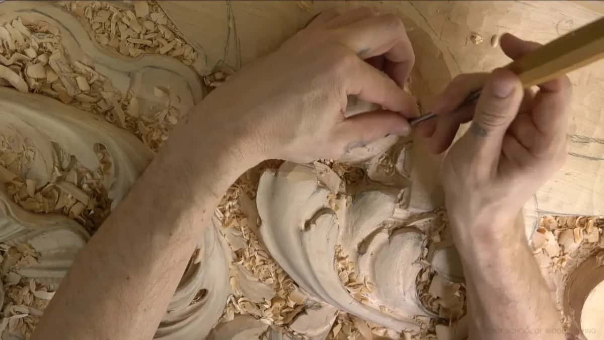 Fingers close around a fine gouge.
