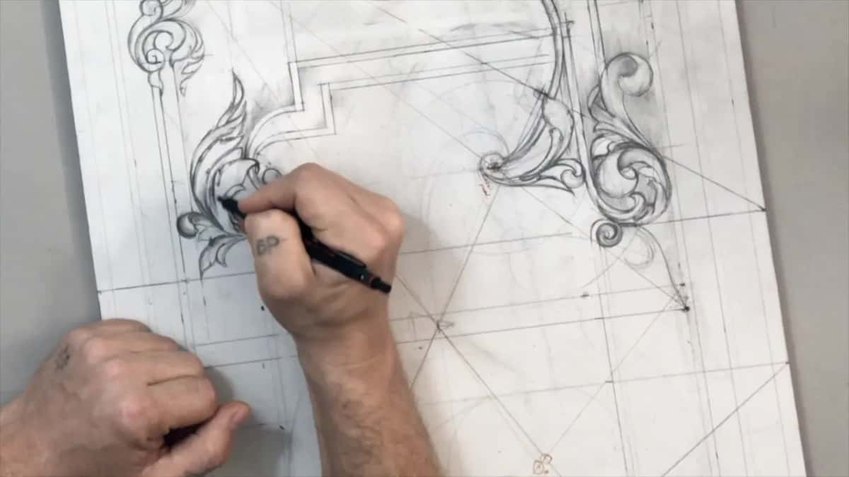 Left hand steadying the board corner as the right draws inside the leaf