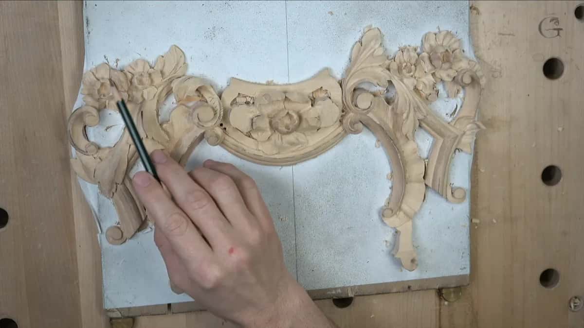 Pencil tip at the left scroll