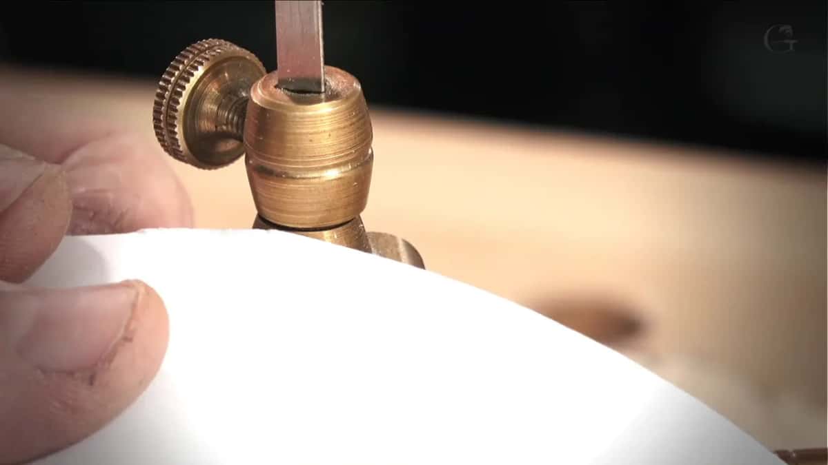 Slip of white paper held under the knurled brass collar