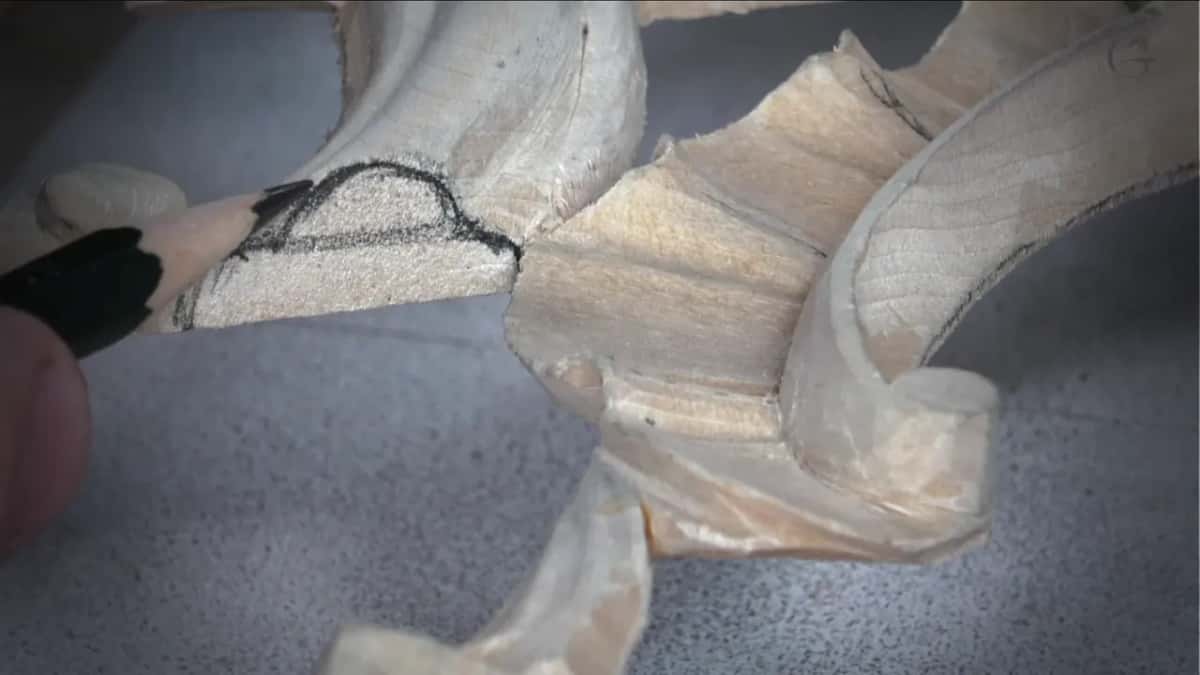 Pencil tip at a curved outline drawn on the end of a carved piece