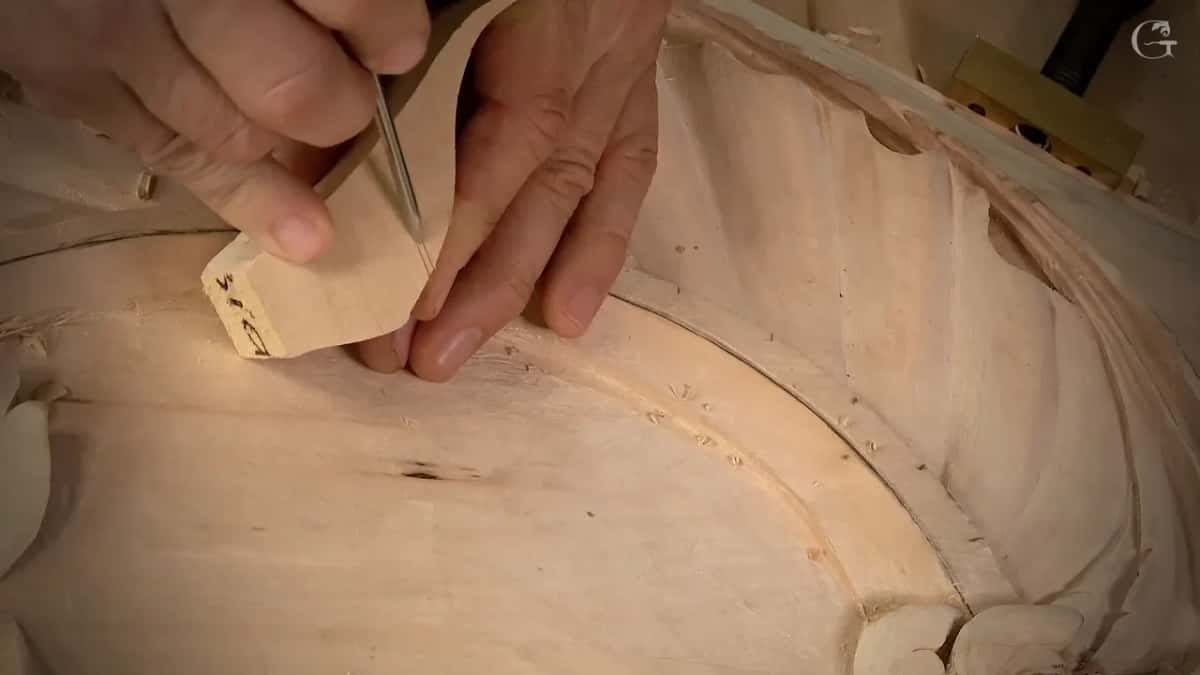 Offcut block with pencil marks, a slim tool pressed into its edge