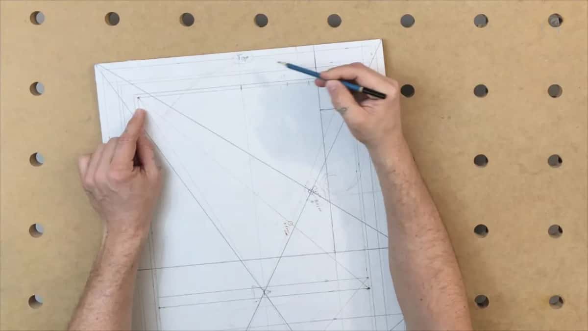 Hand with a pencil at the top corner of the tipped panel