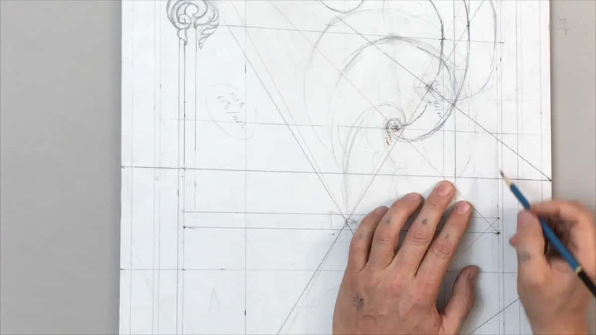 Left hand flat on the sheet, a blue pencil in the right at two long lines near the bottom
