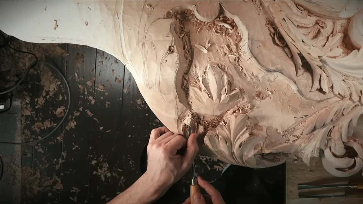 Both hands at the lower lobes, tools lying behind.