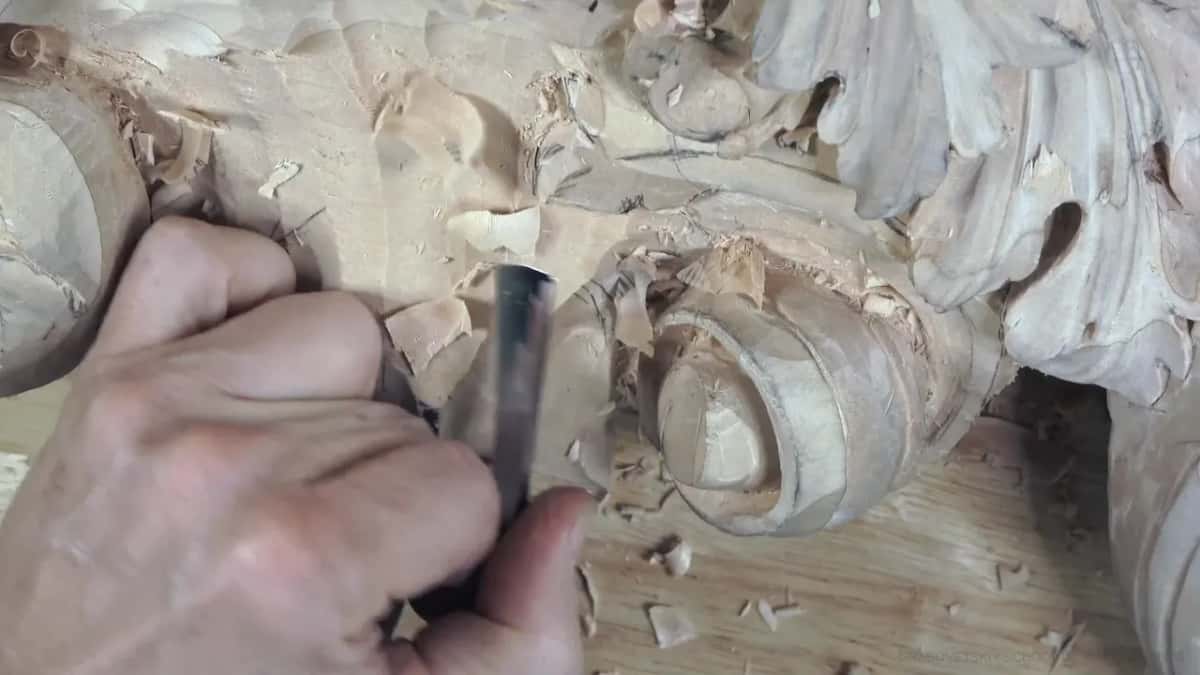 Fingers press a gouge down by the knob.