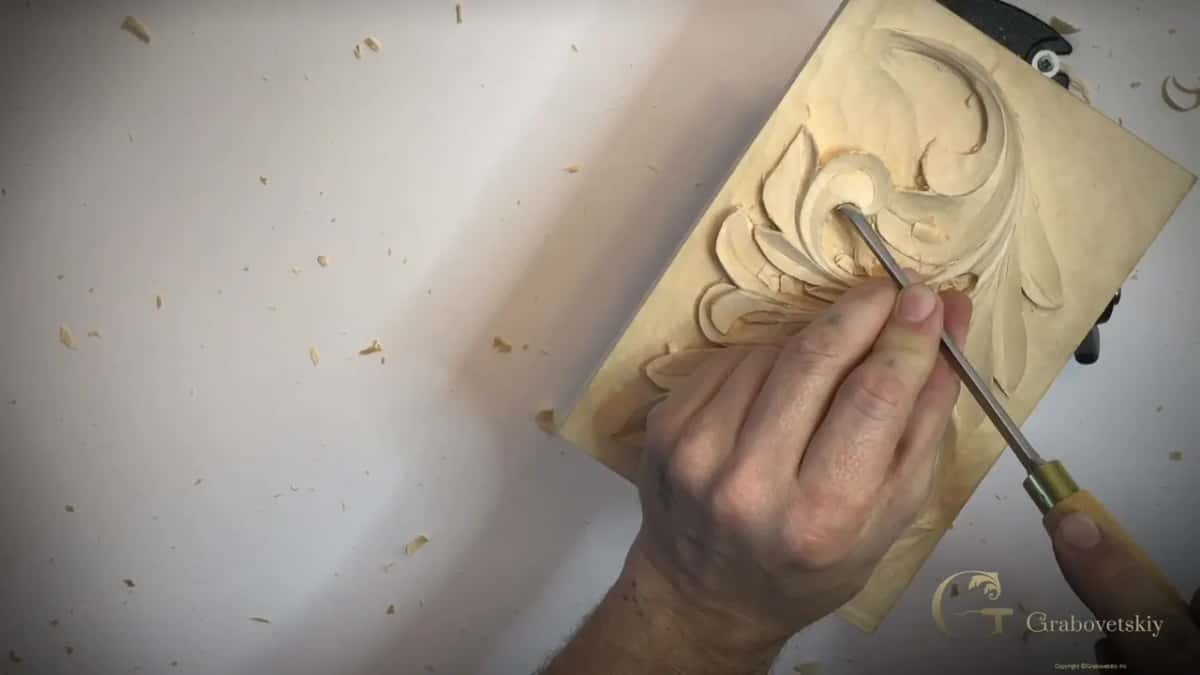 Tilted panel, a long handled tool in at the eye of a curl